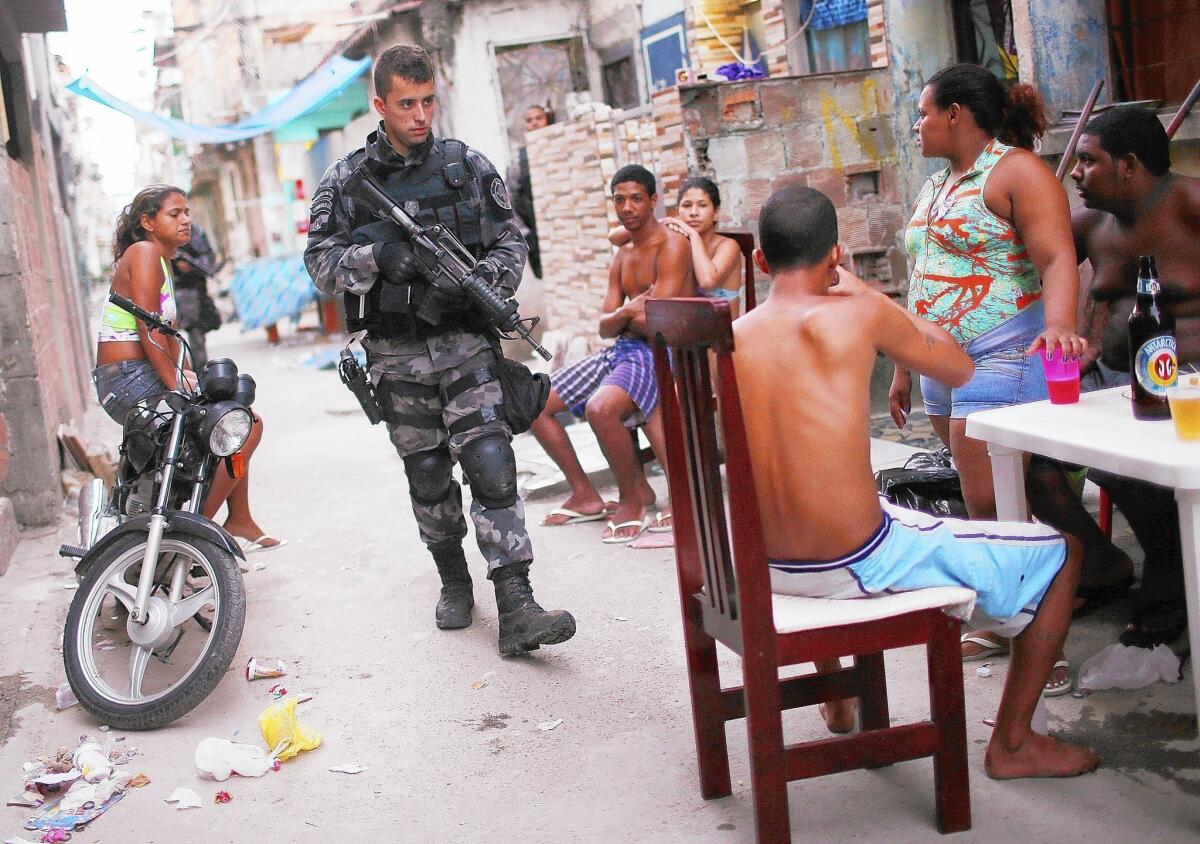 A Brazilian military police officer carries out a patrol in the Complexo da Mare slum in Rio de Janeiro. Seeking to improve public safety, police have established a permanent presence in many of the city's slums.
