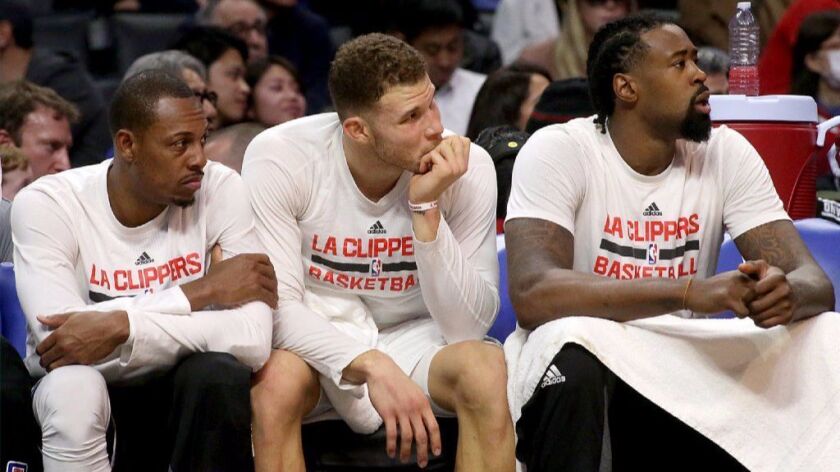 Clippers Paul Pierce, Blake Griffin and DeAndre Jordan (left to right) look on from the bench during a game against the Warriors on Dec. 7.
