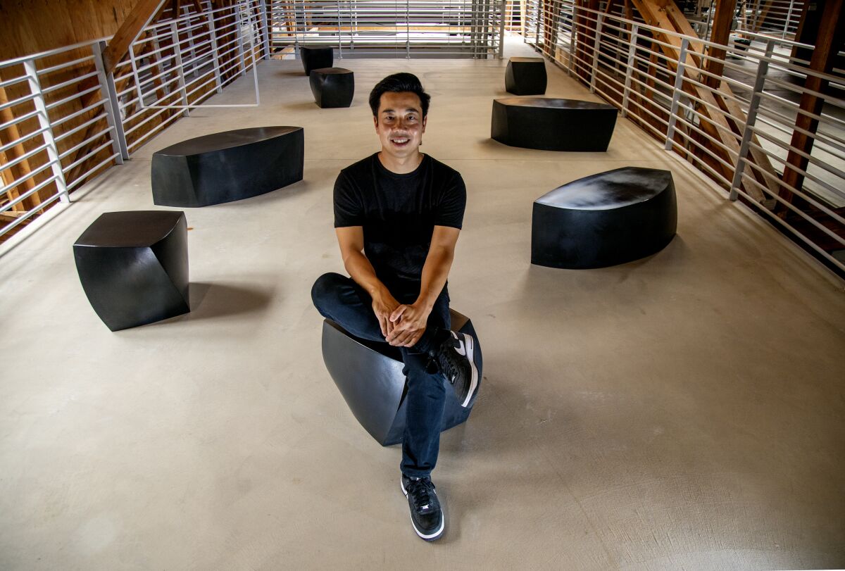 Eddy Lu, CEO of GOAT Group, pictured sitting on a cubic chair.
