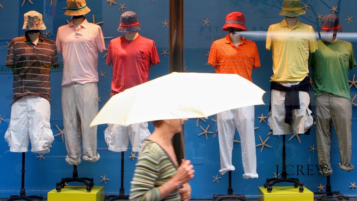 A woman passes a J. Crew store in New York in 2006.