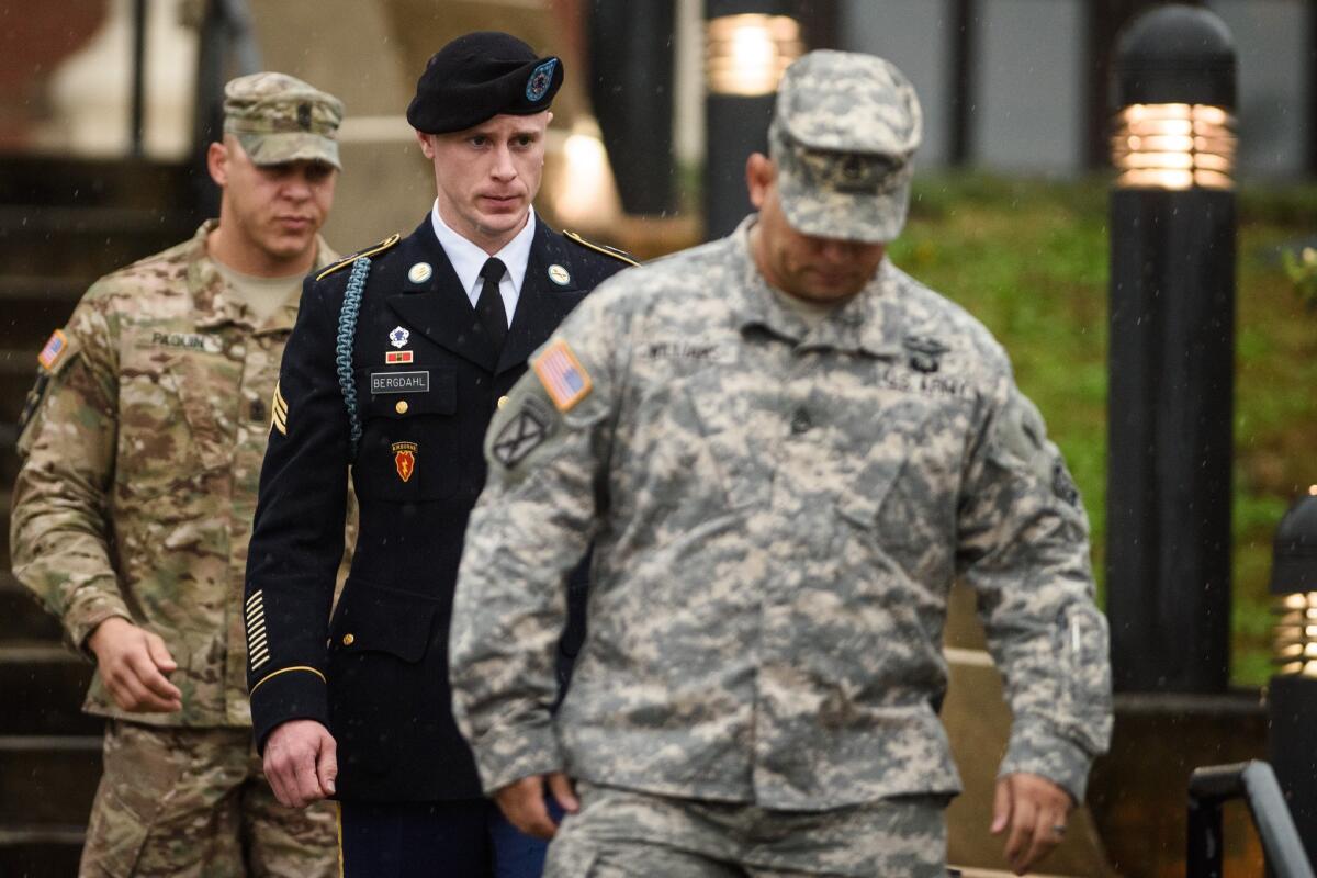 Army Sgt. Bowe Bergdahl, center, leaves the courthouse after his arraignment at Fort Bragg, N.C., in December 2015.