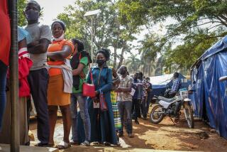 FILE - Ugandans queue to receive Pfizer coronavirus vaccinations at the Kiswa Health Centre III in the Bugolobi neighborhood of Kampala, Uganda Tuesday, Feb. 8, 2022. In the latest Senate package targeted at stopping the coronavirus, U.S. lawmakers dropped nearly all funding for curbing the virus beyond its borders, in a move many health experts describe as dangerously short-sighted. They warn the suspension of COVID aid for poorer countries could ultimately spur the kind of unchecked transmission needed for the next worrisome variant to emerge. (AP Photo/Hajarah Nalwadda, File)