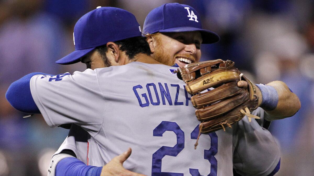 Dodgers first baseman Adrian Gonzalez, left, and third baseman Justin Turner congratulate one another following the team's 2-0 win over the Kansas City Royals on Tuesday.