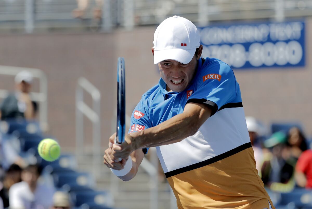FILE - In this Aug. 30, 2019, file photo, Kei Nishikori, of Japan, returns a shot to Alex de Minaur, of Australia, during round three of the US Open tennis championships in New York. Nishikori tested positive for COVID-19 on Sunday, Aug. 16, 2020, and said he will pull out of the tuneup tournament at Flushing Meadows that starts next week. (AP Photo/Eduardo Munoz Alvarez, File)