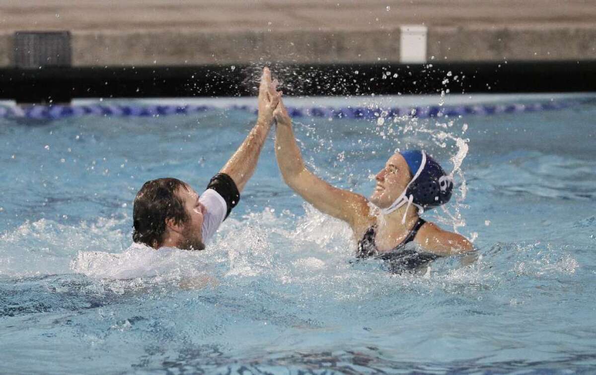 ARCHIVE PHOTO: First-year Crescenta Valley High girls' water polo Coach Brent Danna, left, high fives Caitlin Connell after the Falcons won the CIF Southern Section Division V championship. Danna has been voted the Glendale News-Press top coach of the 2012-13 seasons.