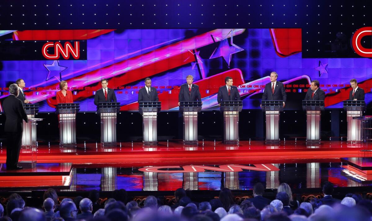 Republican presidential candidates, from left, John Kasich, Carly Fiorina, Marco Rubio, Ben Carson, Donald Trump, Ted Cruz, Jeb Bush, Chris Christie, and Rand Paul respond to debate moderator Wolf Blitzer, far left, during the Republican presidential debate at the Venetian Hotel & Casino in Las Vegas.
