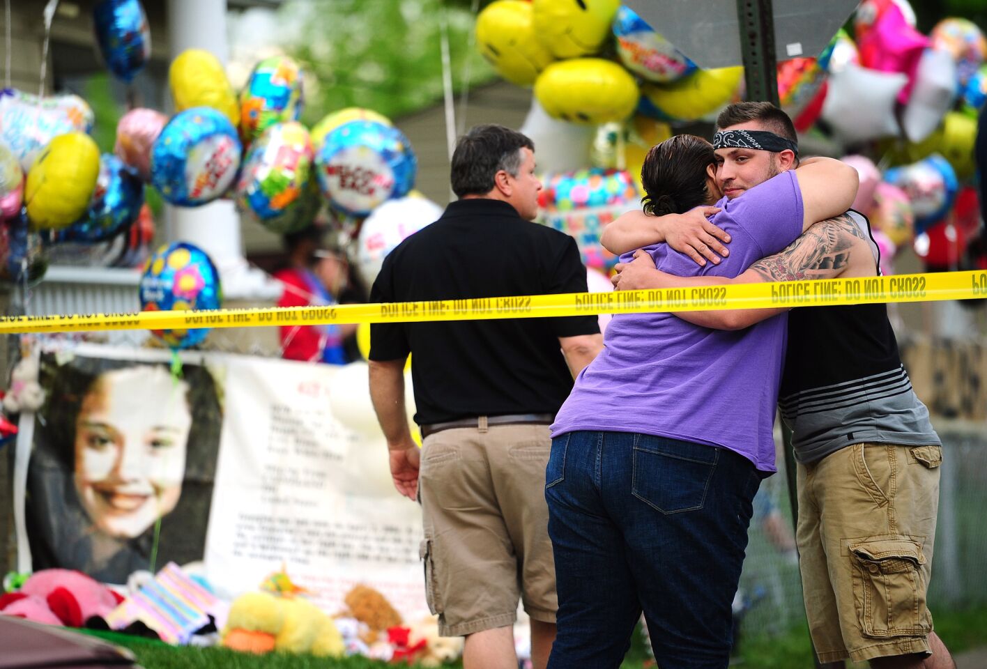 Friends and relatives stand in front of the family home of Gina DeJesus in Cleveland, Ohio.