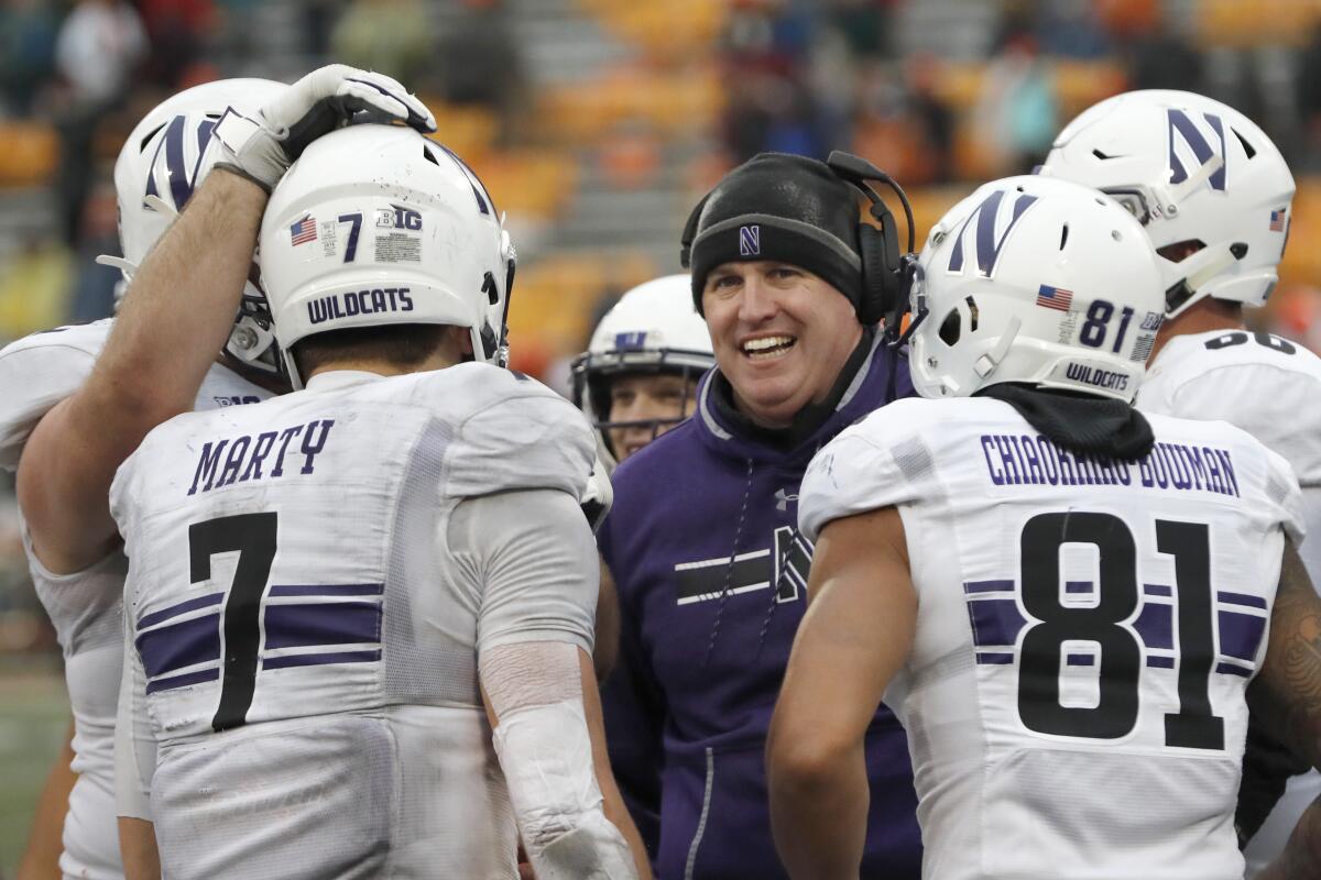 Northwestern coach Pat Fitzgerald smiles at quarterback Andrew Marty