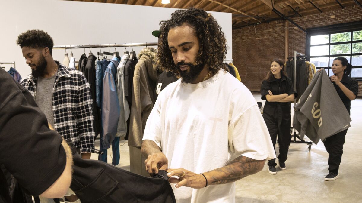 Designer Jerry Lorenzo inspects the details on an item from Fear of God.