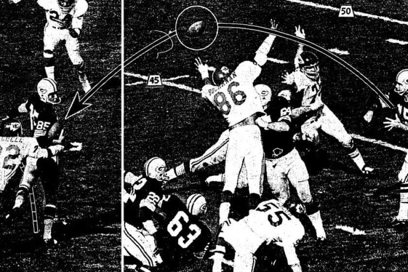 Green Bay's Bart Starr fires a pass toward end Max McGee, who made a one hand grab and then evaded Chiefs' Willie Mitchell (22) for the first Packer score.