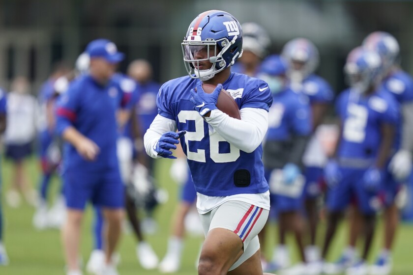 New York Giants running back Saquon Barkley runs the ball during practice.