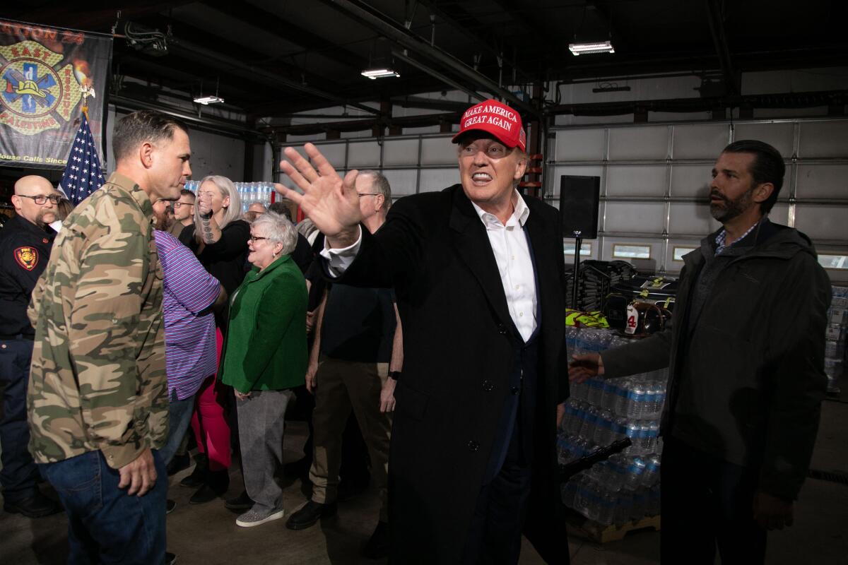 Donald Trump waves while departing an event at the East Palestine Fire Department