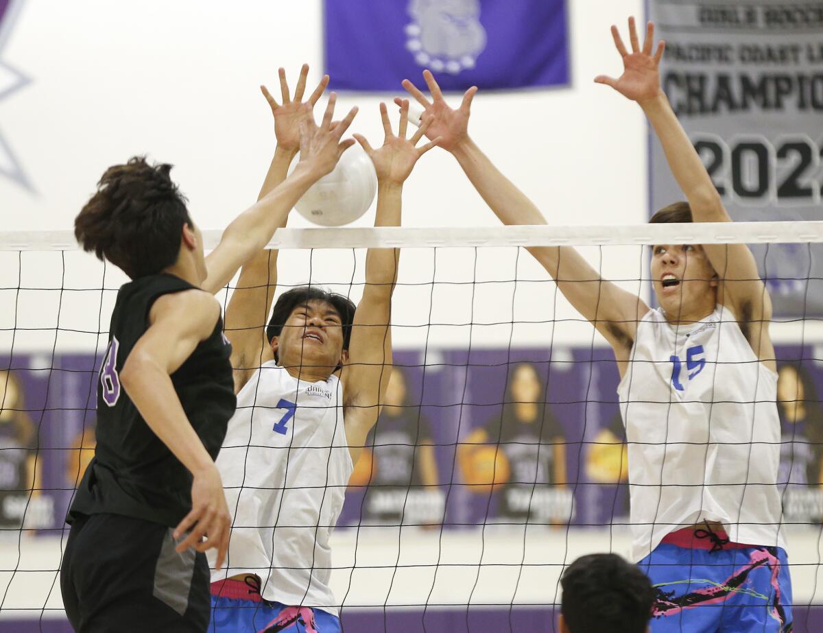 Fountain Valley's Jovanni Dang (7) blocks Portola's Gabriel Kluber Martinez (18) with support from Bennett Heydorn (15).