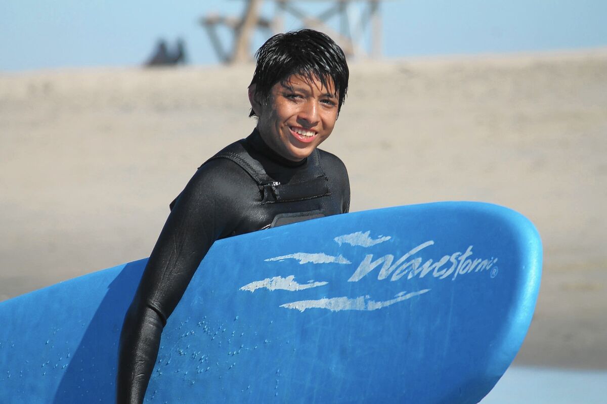 Angel Hernandez is all smiles as he gets out of the water during the annual Save Our Youth surf camp. Angel and 20 other youth from SOY took advantage of the free surf lessons provided by volunteer instructors from Volcom.