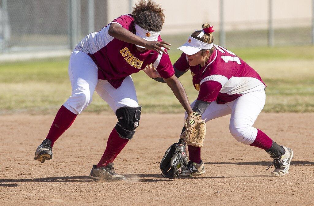 Estancia High's Maya Van Den Heever, left, and Felicia Rios get tangled up attempting to field a ground ball during an Orange Coast League game against Godinez on Tuesday.