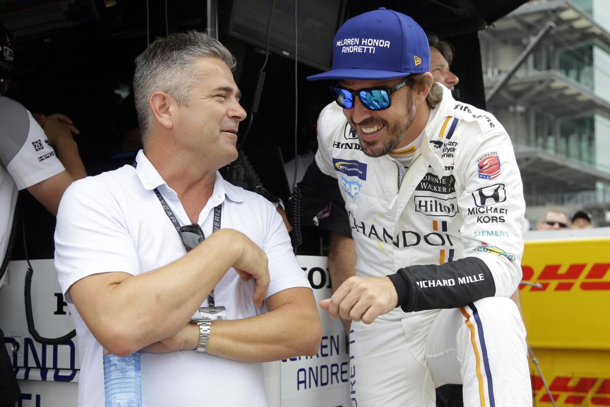 Gil de Ferran, left, talks with race car driver Fernando Alonso during a practice session for the Indianapolis 500.