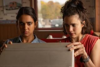 Two women look inside a briefcase.