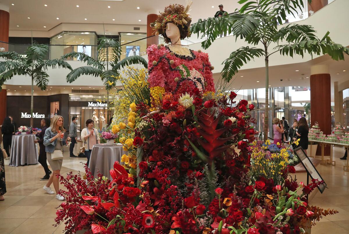 The vibrant figure of Empress Wu Zetian at the "Fleurs de Villes FEMMES" floral exhibit at South Coast Plaza's Jewel Court.