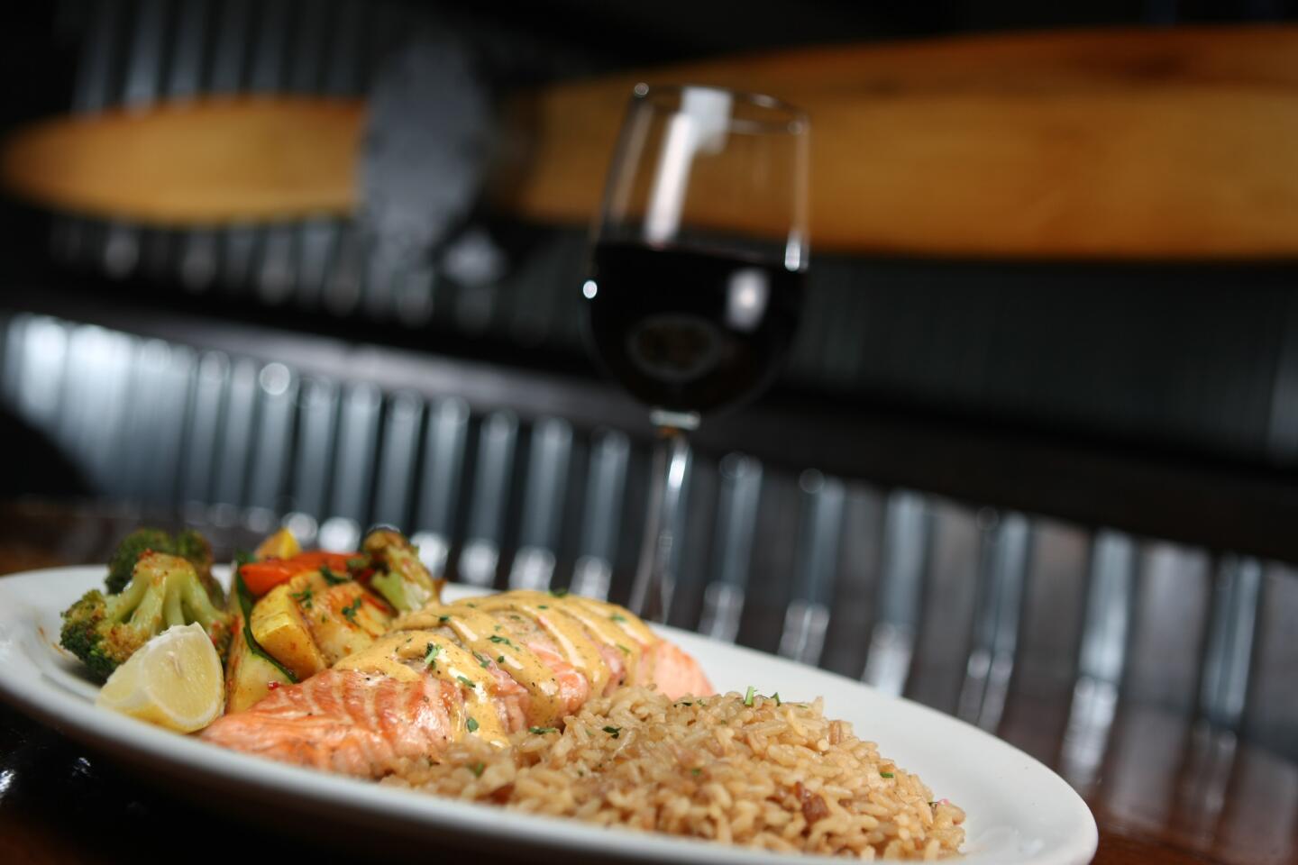 A favorite at the Hanger Grille in Burbank is the fresh grilled salmon stuffed with crab meat filling and topped with a red pepper aioli sauce with a side of rice pilaf and saut¿ed vegetables. Photographed on Thursday, October 29, 2015.