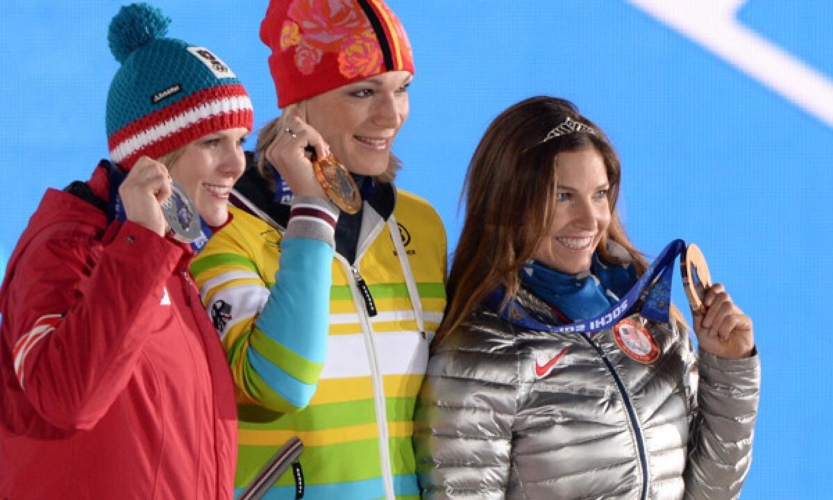 Austria's silver medalist Nicole Hosp, left, Germany's gold medalist Maria Hoefl-Riesch, center, and American bronze medalist Julia Mancuso show off their super-combined medals following a podium ceremony at the 2014 Sochi Winter Olympic Games.