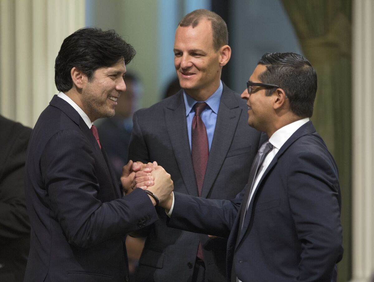 California Senate President Pro Tem Kevin de León (D-Los Angeles), from left, Assemblyman Kevin McCarty (D-Sacramento) and Assemblyman Miguel Santiago (D-Los Angeles) shake hands after a measure to restrict the sale of ammunition was approved by the Assembly.