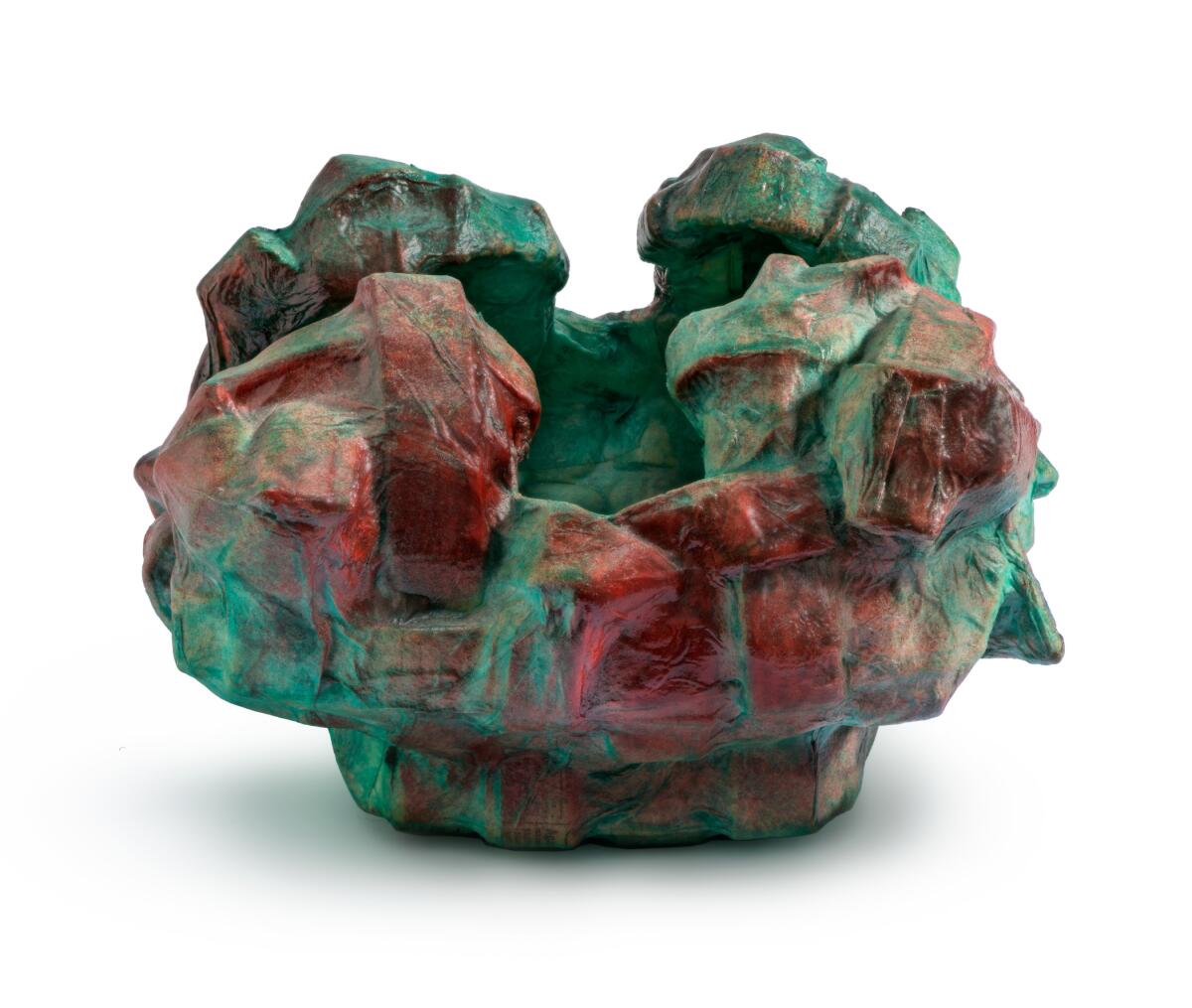 An abstract red and green basket made with rice paper, newspaper and lacquer. 