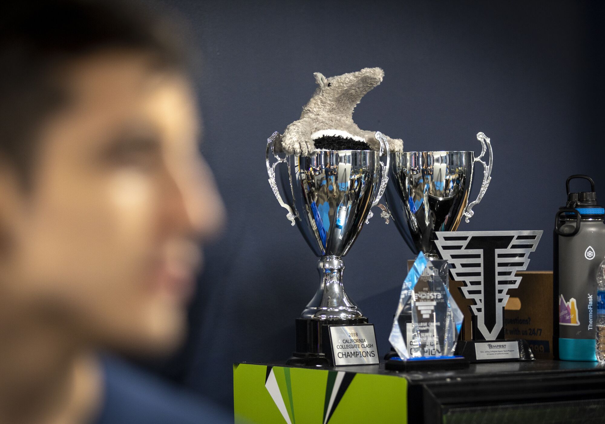 A view of UCI esports gaming trophies with Phillip Rodriguez.