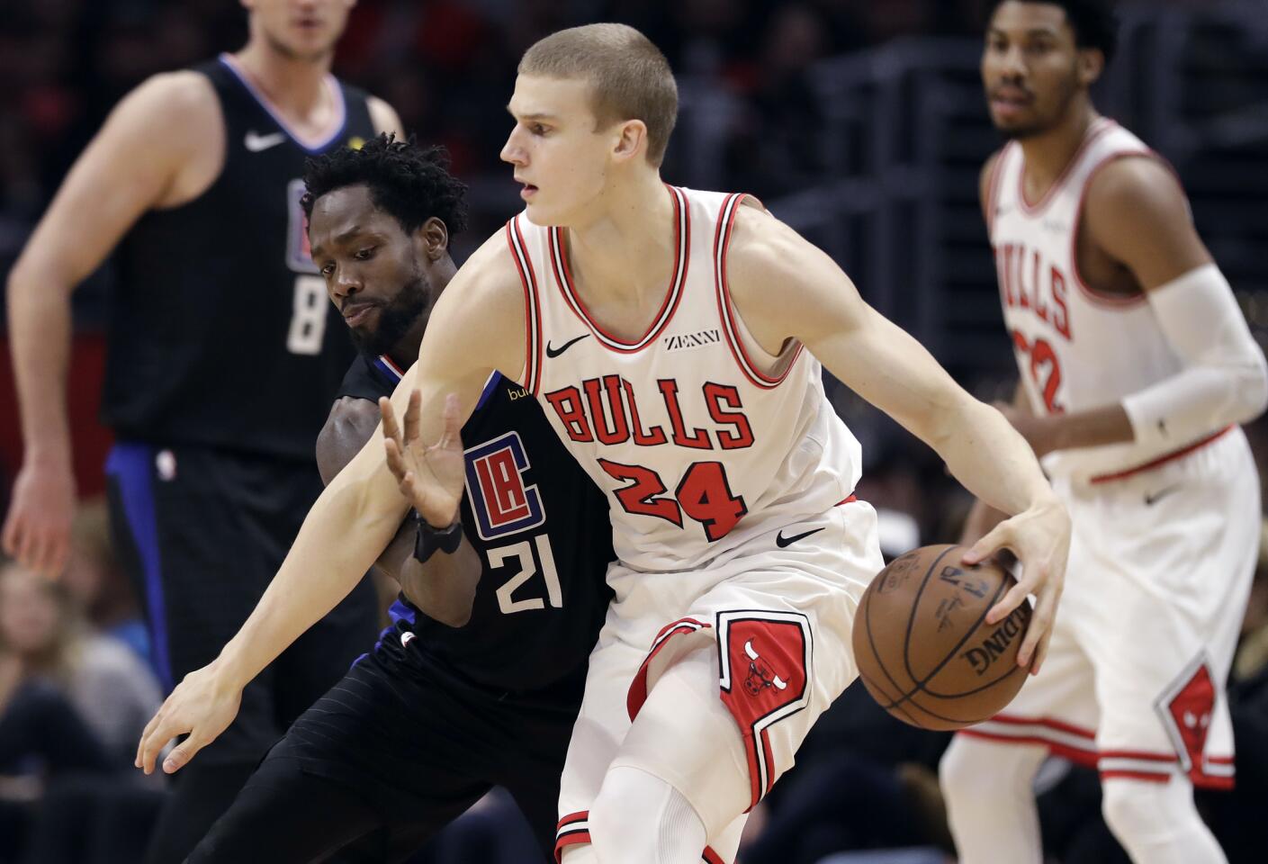 Chicago Bulls' Lauri Markkanen (24) is defended by Los Angeles Clippers' Patrick Beverley (21) during the second half of an NBA basketball game Friday, March 15, 2019, in Los Angeles. (AP Photo/Marcio Jose Sanchez)