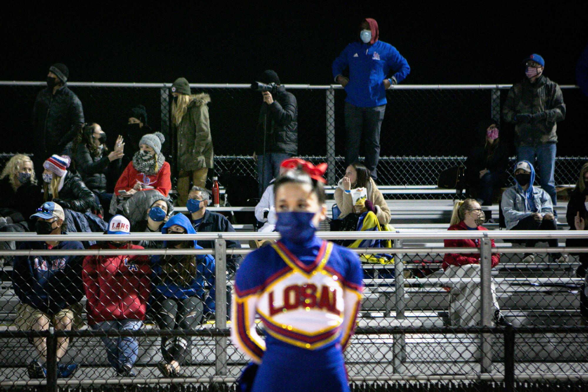  Fans in the stands watch Los Alamitos play their first game of the season.