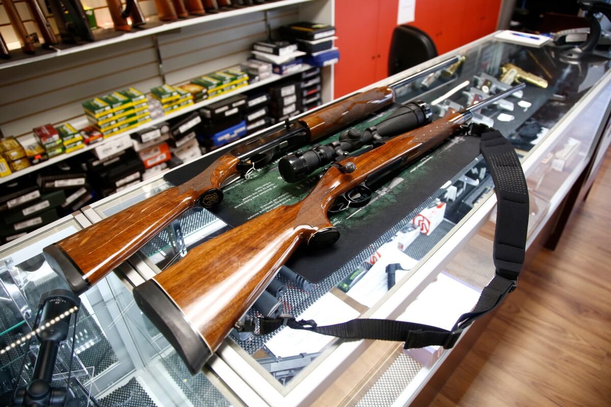 A Remington 700 hunting rifle and a Remington 1100 shotgun are seen for sale at a North Carolina gun shop. 