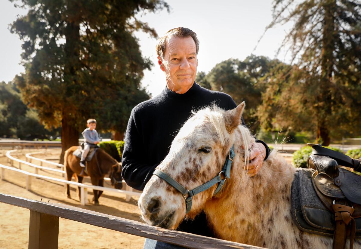 Owner Stephen Weeks pets a pony.
