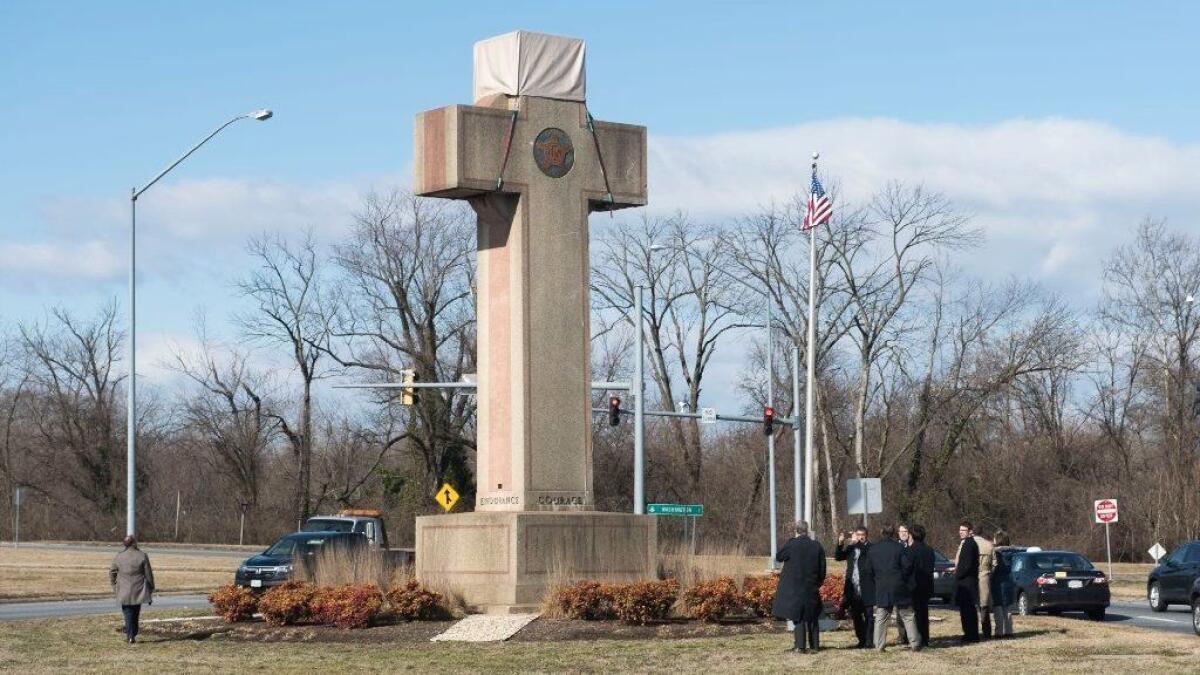 Visitors walk around the 40-foot Maryland Peace Cross dedicated to World War I soldiers on Wednesday, Feb. 13, 2019 in Bladensburg, Md.