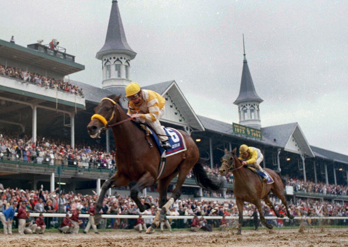 FILE - Jockey Chris McCarron rides Go For gin across the finish line to win the 120th running of the Kentucky Derby horse race at Churchill Downs in Louisville, Ky., May 7, 1994. In back is second-place finisher Strodes Creek with jockey Eddie Delahoussaye. Go For Gin, the race’s oldest living winner, has died. He was 31. Kentucky Horse Park announced on its web site that Go For Gin died Tuesday, March 8, 2022, from heart failure. He had lived there since retiring from stud in June 2011. (AP Photo/John Swart, File)