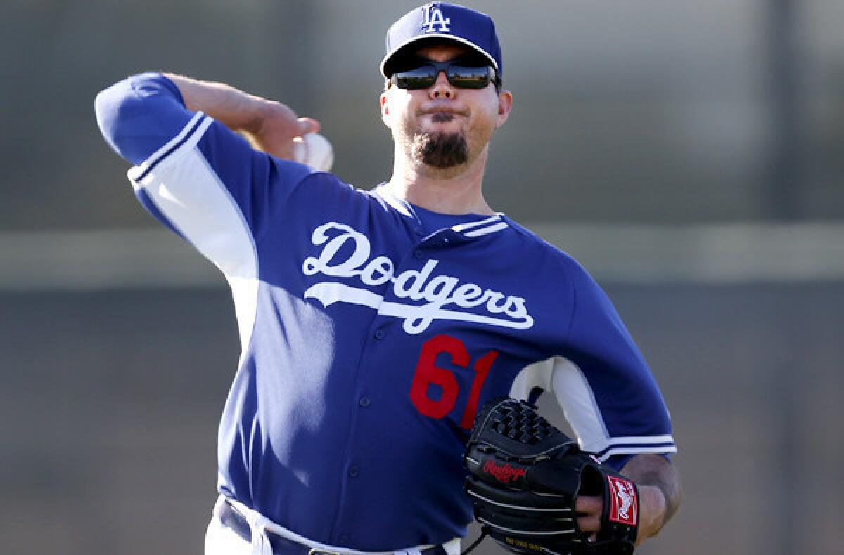 Josh Beckett, loosening up during a workout last month, made his debut Sunday, pitching for the first time in a game since May 13 of last season.