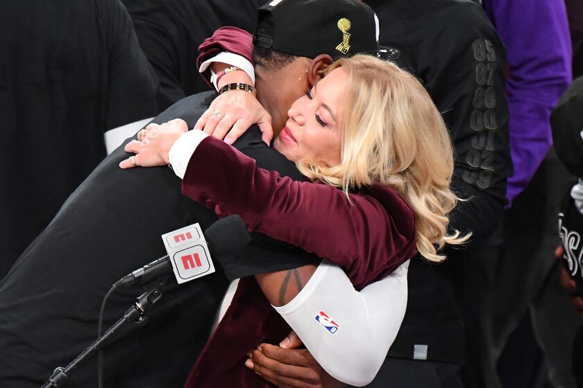 ORLANDO, FLORIDA OCTOBER 11, 2020- Lakers owner Jeannie Buss gets a hug from LeBron James after winning the NBA Championship in Game 6 of the NBA FInals in Orlando Sunday. (Wally Skalij/Los Angeles Times)