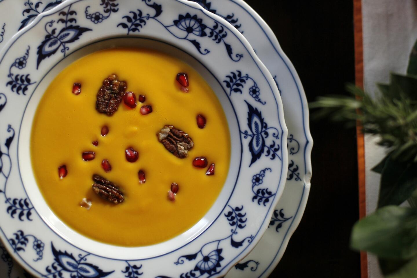 Kabocha squash soup with pomegranate seeds and spicy candied pecans