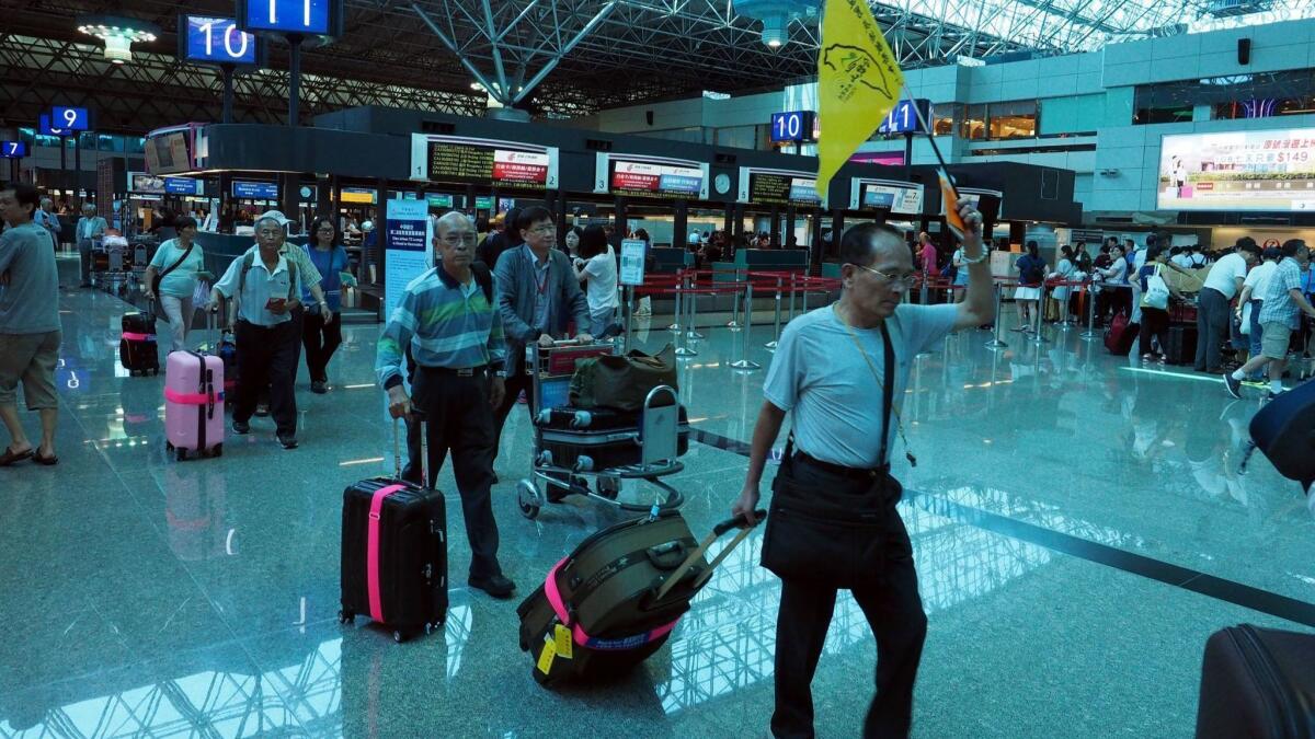 Travelers at Taoyuan International Airport in Taoyuan City, northern Taiwan. China has put pressure on airlines flying to China as well as to the International Air Transport Association (IATA) to order airlines to change Taiwan destinations as part of China.