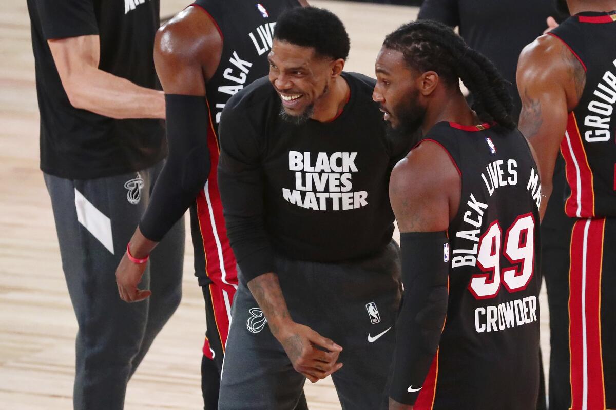 Miami Heat forward Udonis Haslem, center, and forward Jae Crowder (99) celebrate their win.