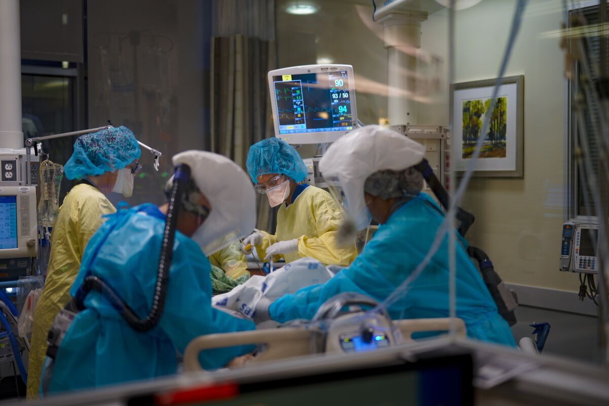 ICU nurses care for a patient diagnosed with COVID-19 at Sharp Grossmont Hospital in La Mesa last December.
