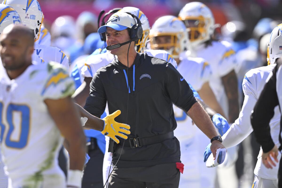 Coach Brandon Staley celebrates with players after the Chargers scored a touchdown.