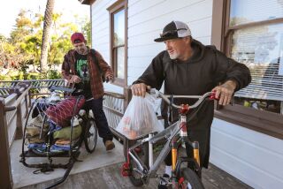 April 30, 2021_Carlsbad, California, USA_| Homeless Travis Ramirez, 38, left, and Donny Barker, 52, at right, get their belongs together to leave from the back porch of the historic Magee House at Magee Park where they and others spent the night. |_Photo Credit: Photo by Charlie Neuman