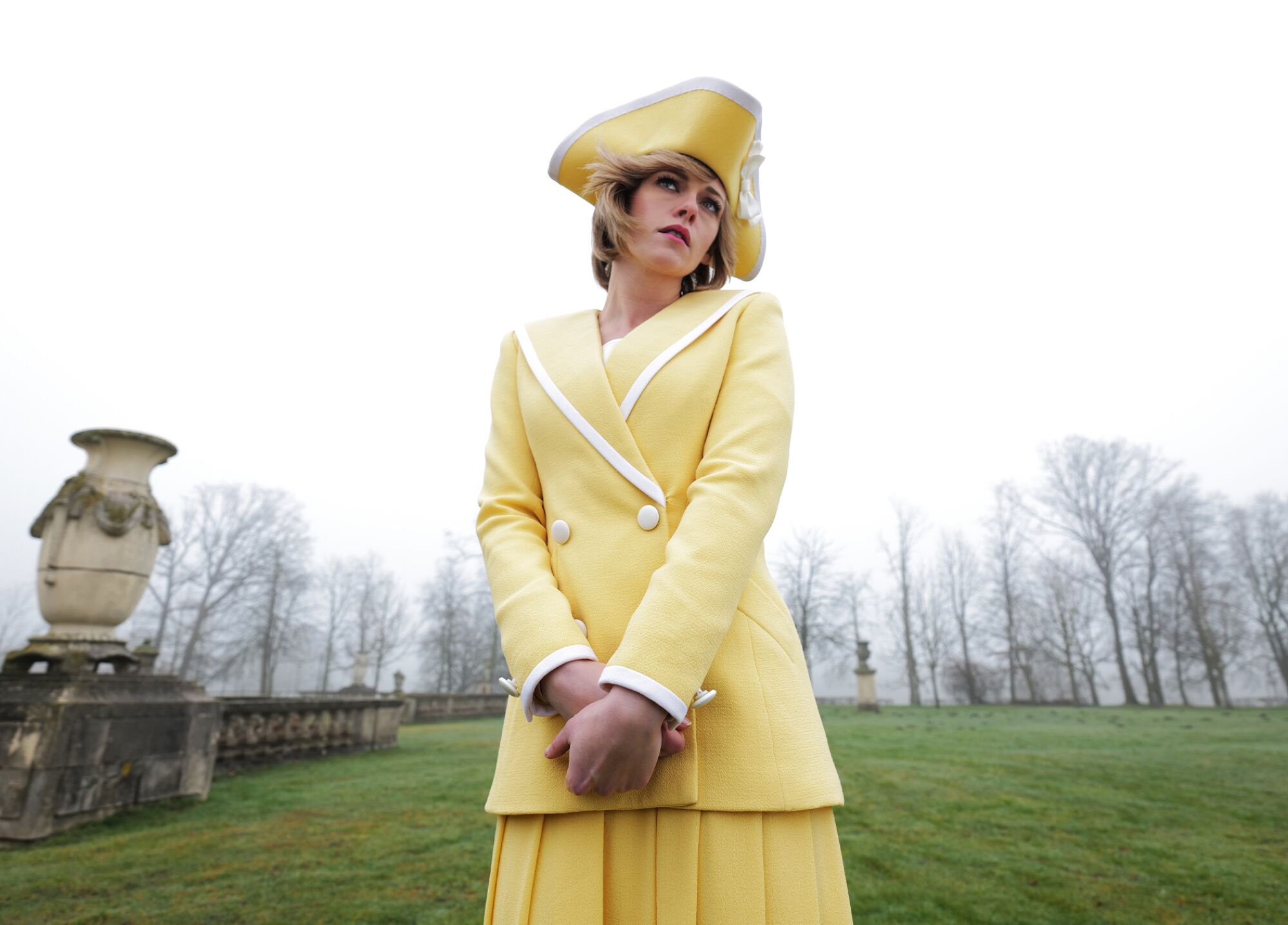 Kristen Stewart wears a yellow sailor suit with pirate hat as Princess Diana in "Spencer."