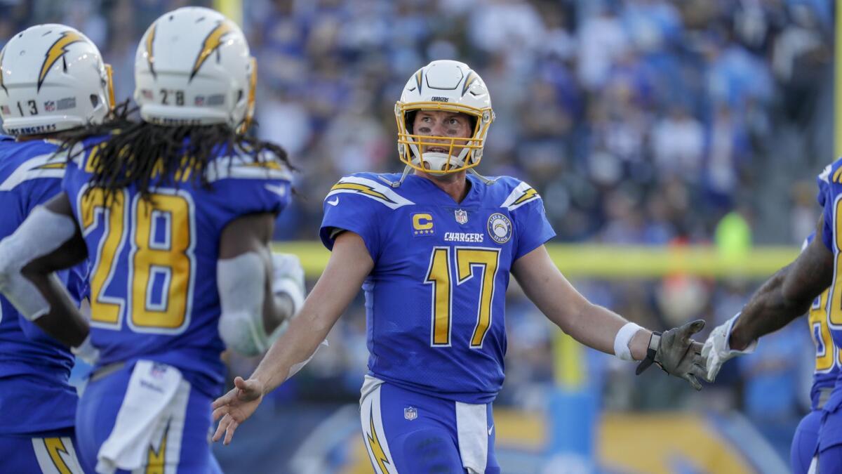 Chargers quarterback Philip Rivers exchanges handshakes with teammates after leading the offense on a scoring drive against the Arizona Cardinals at StubHub Center.