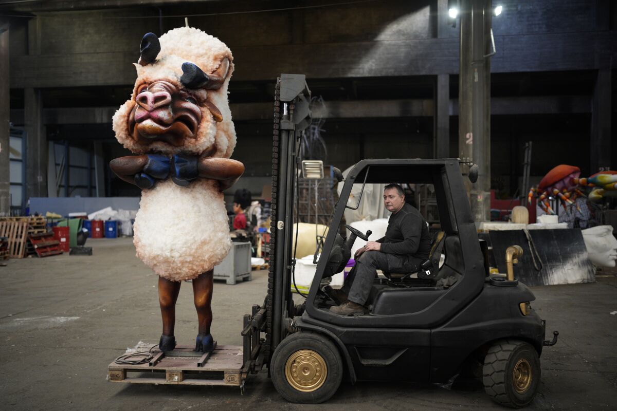 Artisan Pierre Povigna moves a carnival figure at a warehouse in Nice, southern France, Thursday, Feb. 10, 2022. The theme of the Carnival's 149th edition in the French Riviera city of Nice is King of Animals. A loud celebration of nature, human connection and life itself after months of lockdowns, silence, social distancing and banned public gatherings, kicks off on Friday. (AP Photo/Daniel Cole)