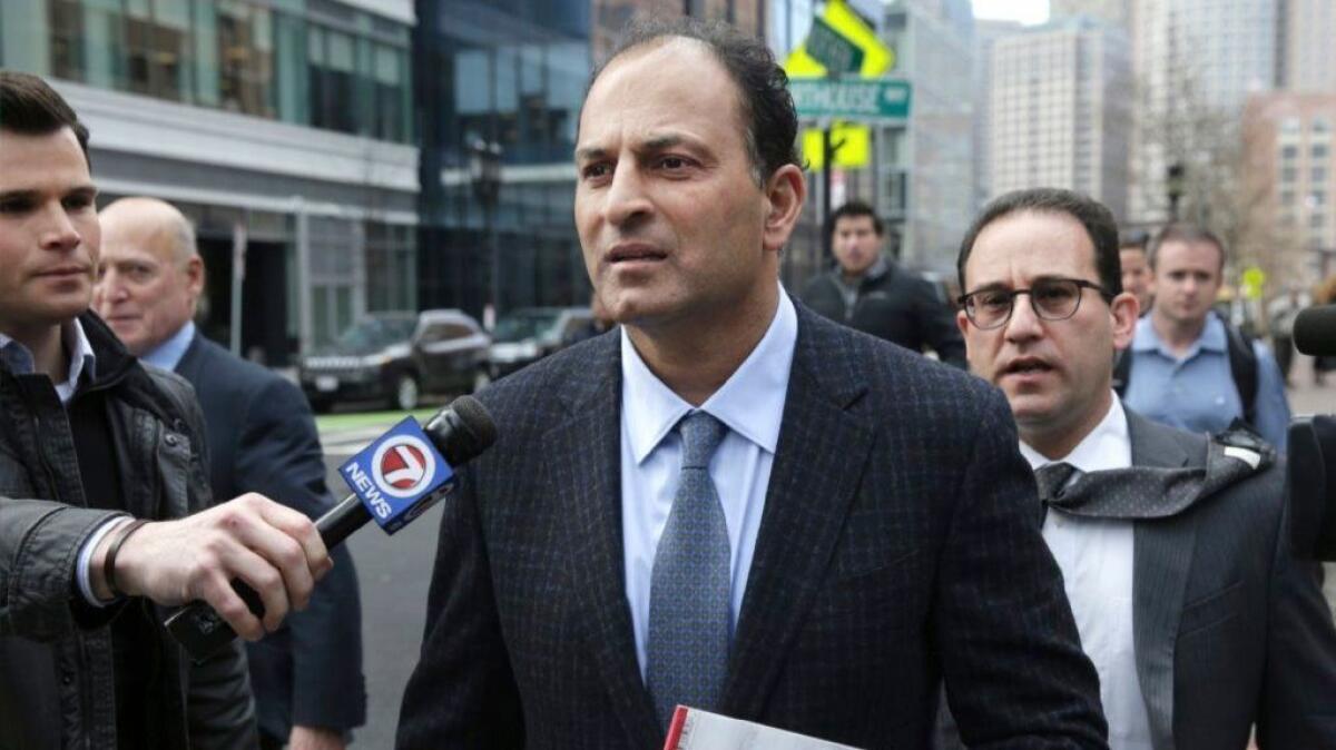 David Sidoo of Vancouver leaves a federal court hearing March 15 in Boston. Sidoo pleaded not guilty to charges in a wide-ranging college admissions scandal.