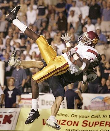 USC freshman receiver Dwayne Jarrett is able to get in the right position to catch a 15-yard pass from quarterback Matt Leinart against BYU on September 18, 2004.