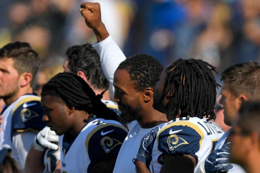 Los Angeles Rams linebacker Robert Quinn raises his fist during the playing of the national anthem before a preseason NFL football game against the Los Angeles Chargers, Saturday, Aug. 26, 2017, in Los Angeles. (AP Photo/Mark J. Terrill)