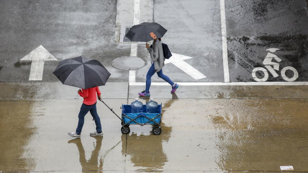 Pedestrians at USC during a March 22 storm in Los Angeles.