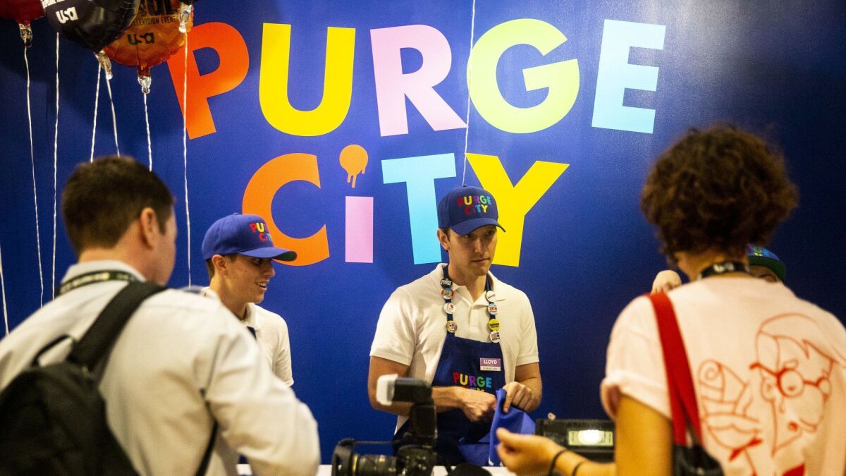 People are helped at the check out line at the "Purge City" activation, during the second day of the 2018 San Diego Comic-Con International.