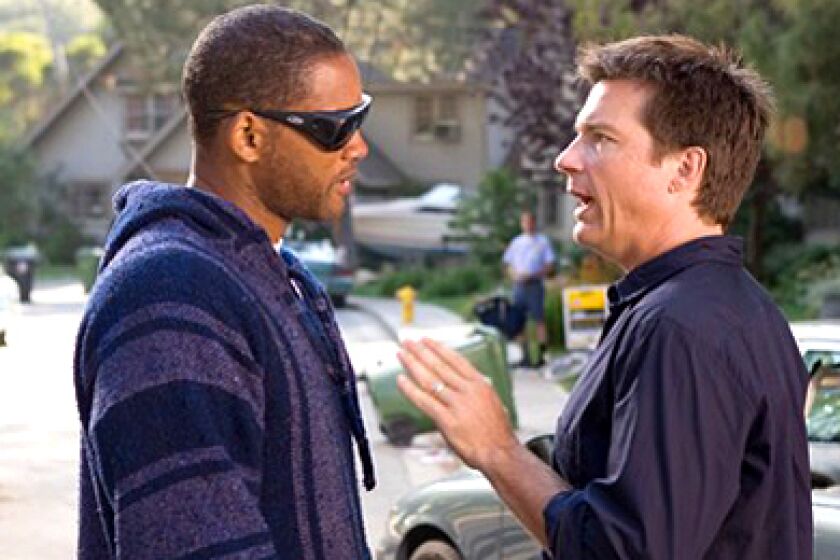 Will Smith, left, plays Hancock, opposite PR Exec Ray Embrey, played by Jason Bateman, right.